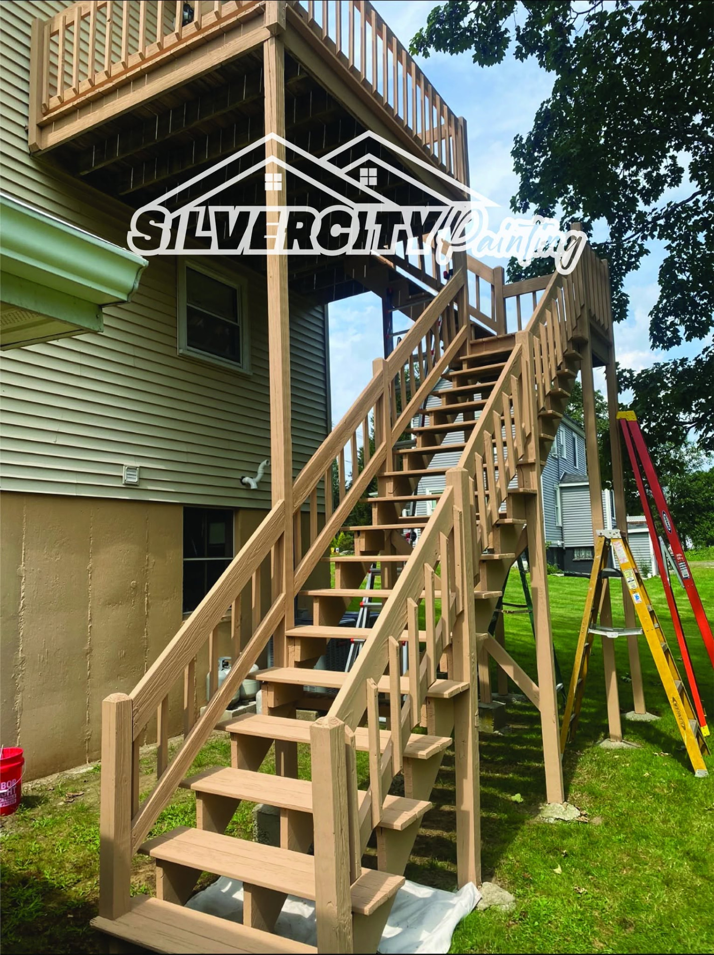 Two-story deck staircase washed and coated in warm tan solid stain